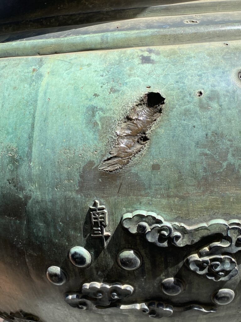a deep scar in a gren metal surface