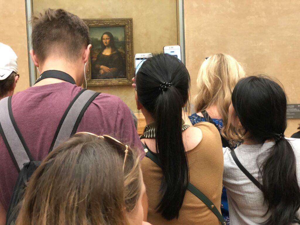 people standing in front of a painting